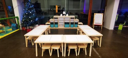 a group of tables and a christmas tree in a room at Arena Franz Ferdinand Nassfeld in Tröpolach