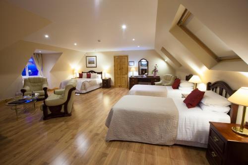 a hotel room with two beds and a desk at The Tides Ballybunion in Ballybunion