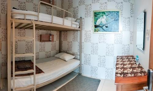 a bunk bed room with two bunk beds in it at The Cabin Purwokinanti Hotel in Yogyakarta