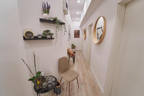 a hallway with a chair and a mirror at AK7 Boutique Suites in Budapest