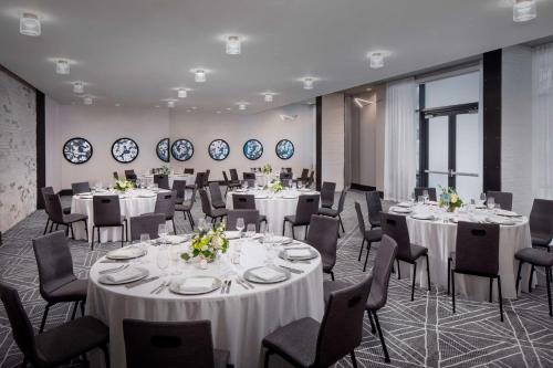 a conference room with white tables and chairs at Andaz Savannah, By Hyatt in Savannah