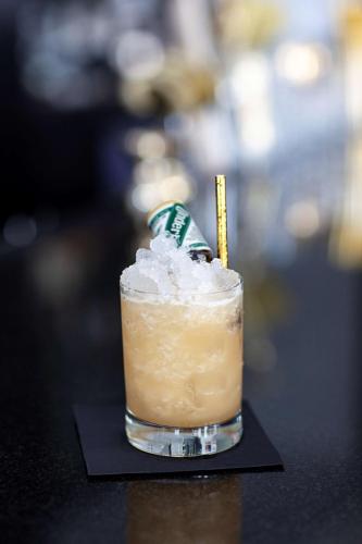 a drink sitting on top of a black table at Andaz Savannah, By Hyatt in Savannah