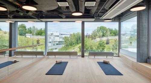 a yoga room with benches and large windows at Hyatt Regency Zurich Airport Circle in Kloten