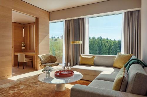 a living room with a couch and a table at Hyatt Regency Zurich Airport Circle in Kloten