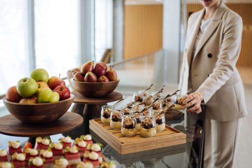 a woman standing in front of a buffet of food at Hyatt Regency Zurich Airport Circle in Kloten