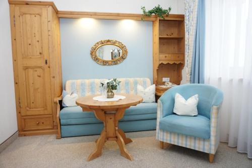 a room with a table and two chairs and a mirror at Landhaus Achental in Pertisau
