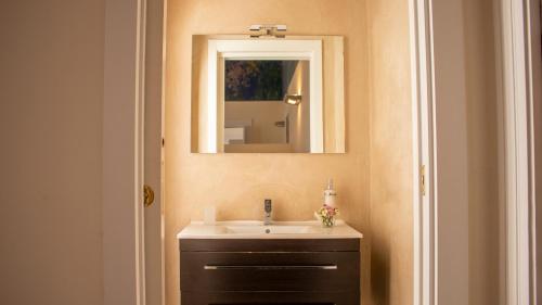 a bathroom with a sink and a mirror at Apollo Suites in Lecce
