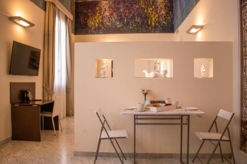 comedor con mesa y sillas en Apollo Suites, en Lecce