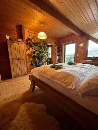a bedroom with a large bed in a wooden room at Skigebiete Stuhleck und Semmering,Wandergebiete Schneeberg und Rax in Neunkirchen