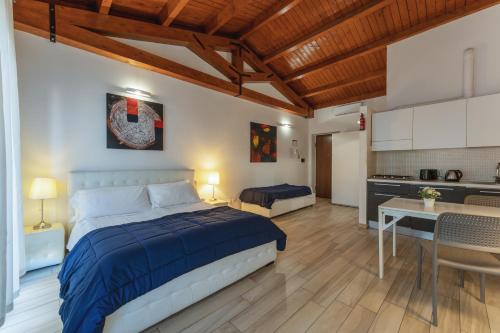 a large bedroom with a bed and a kitchen at Dalmati House San Lorenzo in Rome