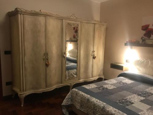 a bedroom with a large cabinet with a mirror at La Gardenia in Montecatini Terme