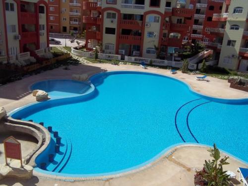 a large swimming pool in front of some apartment buildings at Super Deluxe apartment with 3 Bed rooms in Sharm El Sheikh