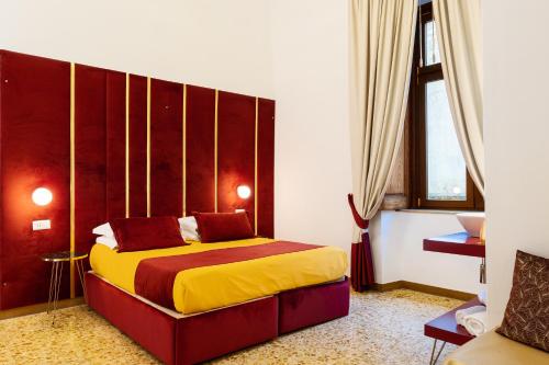 a bedroom with a bed with a wooden headboard at La Lepre felice-bovio in Naples