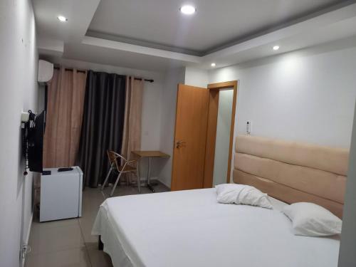 a bedroom with a large white bed in a room at Pull Up in Praia