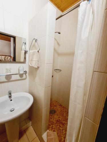 a white bathroom with a sink and a shower at garni Hotel ASAS*** in Most