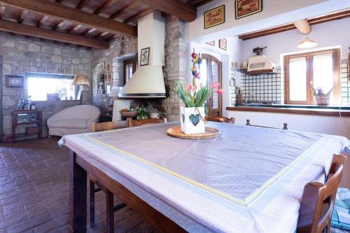 a dining room table with a blue table cloth on it at Villa I Camini - Outbuilding, dependance - Swimming pool - Garden - BBQ and fireplaces - Soccer field in Monte Castello di Vibio