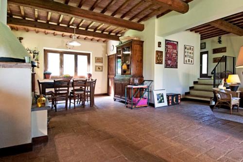 a living room with a table and a dining room at Villa I Camini - Outbuilding, dependance - Swimming pool - Garden - BBQ and fireplaces - Soccer field in Monte Castello di Vibio