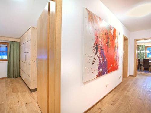 a living room with a painting on the wall at Apartment in Wald near Ski Slopes in Wald im Pinzgau