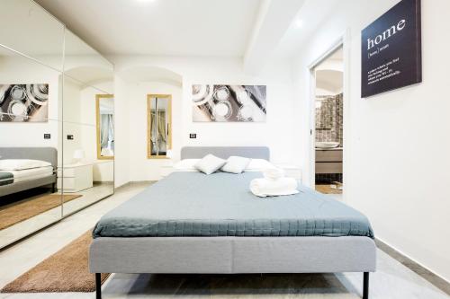 Habitación blanca con cama y espejos en Maccaja House by HolidayHome24, en Génova