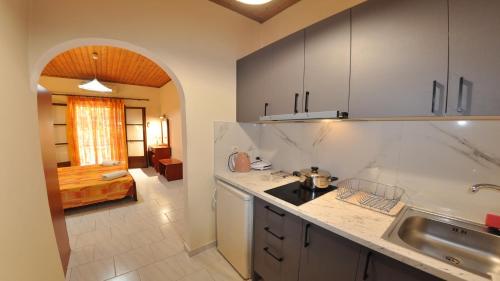 a kitchen with a sink and a counter top at Villa Katerina Apartments in Liapades