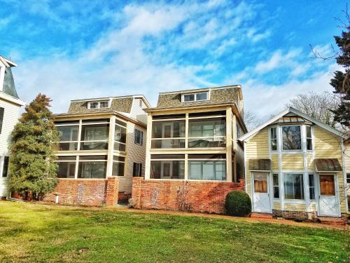 a large house with a brick wall at Sandaway Suites & Beach in Oxford