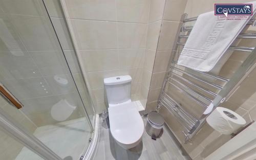 a small bathroom with a toilet and a shower at Victoria House - Deluxe Studios in Coventry City Centre, free parking, by COVSTAYS in Coventry