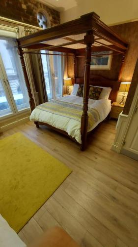 a bedroom with a canopy bed and a rug at 43A Crown Street in Halifax