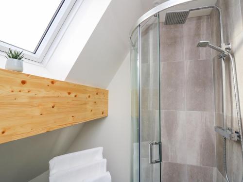 a shower in a bathroom with a skylight at Elan Valley Welsh - The Sheepfold in Llandrindod Wells