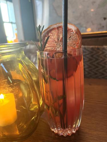 a drink in a glass next to a candle at Stein Inn in Stein