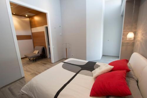 a bedroom with a large bed with red pillows at Catalunya Casas Modern Marvel,15 min to Costa Brava beaches! in Sils