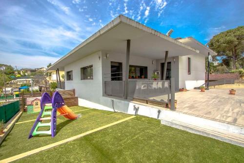 a house with a yard with a slide at Catalunya Casas Modern Marvel,15 min to Costa Brava beaches! in Sils