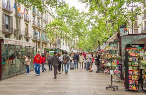 a group of people walking down a street in a city at Catalunya Casas Modern Marvel,15 min to Costa Brava beaches! in Sils