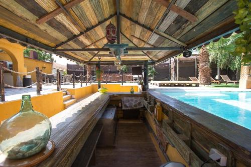an outdoor pool with a table and a vase next to it at Catalunya Casas Relax and Recharge - only 34km from Barcelona! in Rubí