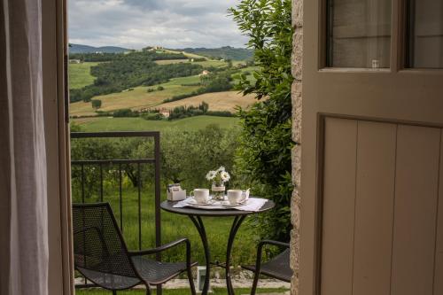 a table and chairs on a balcony with a view at Roccafiore Wine Resort & Spa in Todi