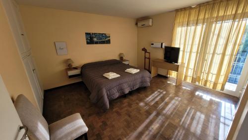 1 dormitorio con 1 cama y TV en Departamento Alpatacal en Mendoza