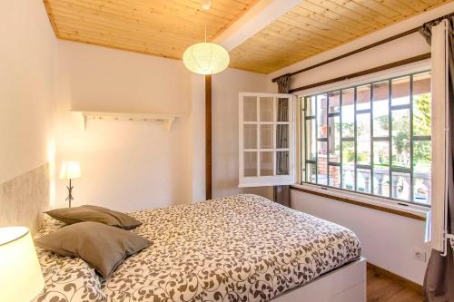 a bedroom with a bed and a large window at Catalunya Casas Costa Brava villa with private pool & spacious garden in Santa Coloma de Farners