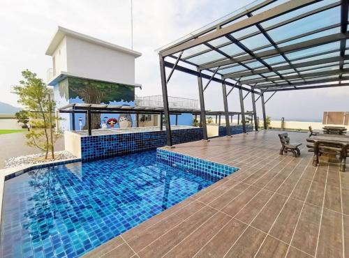 a house with a swimming pool and a patio at FREE WIFI-FI Travelers HomestySitiawan 5-8pax The Venus Aparment in Seri Manjung