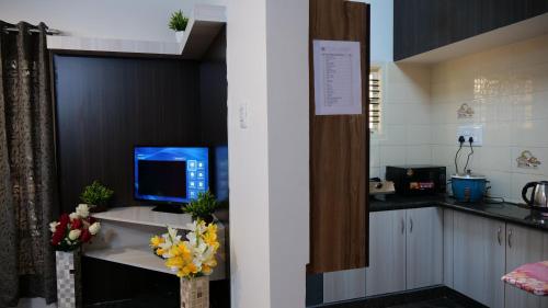 a kitchen with a desk with a computer on it at The Ventura Grand Hotel in Bangalore