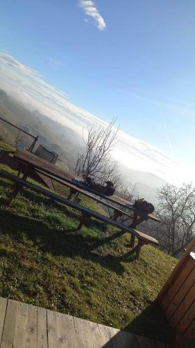 a wooden picnic table sitting on top of a field at Turistična kmetija Golej in Podčetrtek