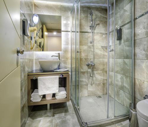 a bathroom with a shower and a sink at Hotel Bossuite Kadikoy in Istanbul