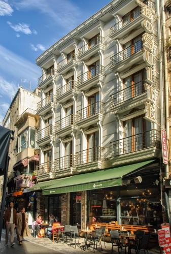 a tall white building with people walking in front of it at Hotel Bossuite Kadikoy in Istanbul