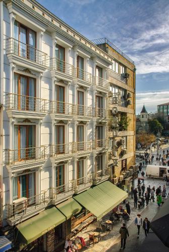 a large white building with people walking in front of it at Hotel Bossuite Kadikoy in Istanbul