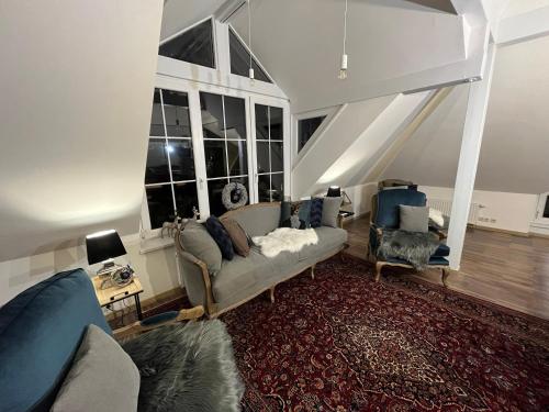 a living room with a couch and a chair at Chalet Embacher by AlpenTravel in Bad Gastein