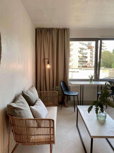 a living room with a couch and a table at Edville Studio in Ghent