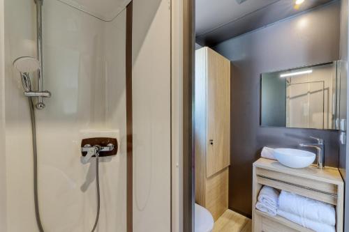 a bathroom with a shower and a toilet and a sink at Nantes Camping Le Petit Port in Nantes