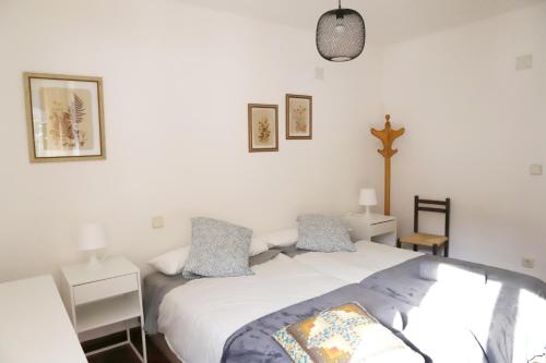 a bedroom with a bed and a cross on the wall at Apartamento La Campa in Canfranc-Estación