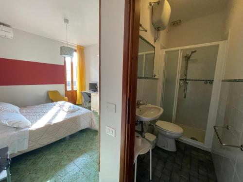 a bedroom with a bed and a sink and a toilet at Hotel Azzi in Florence