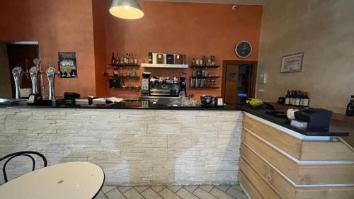 a bar in a restaurant with a brick wall at IL Contado B&B in Castel SantʼElia