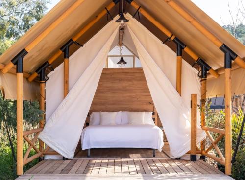 a tent bedroom with a bed in it at wecamp Santa Cristina in Santa Cristina d'Aro