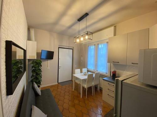 a kitchen with a table and a dining room at Casa Vittoria in Zelo Buon Persico